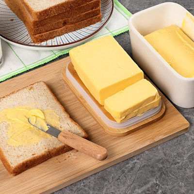 Белое керамическое блюдо масла с крышкой и ножом для счетчика кухни